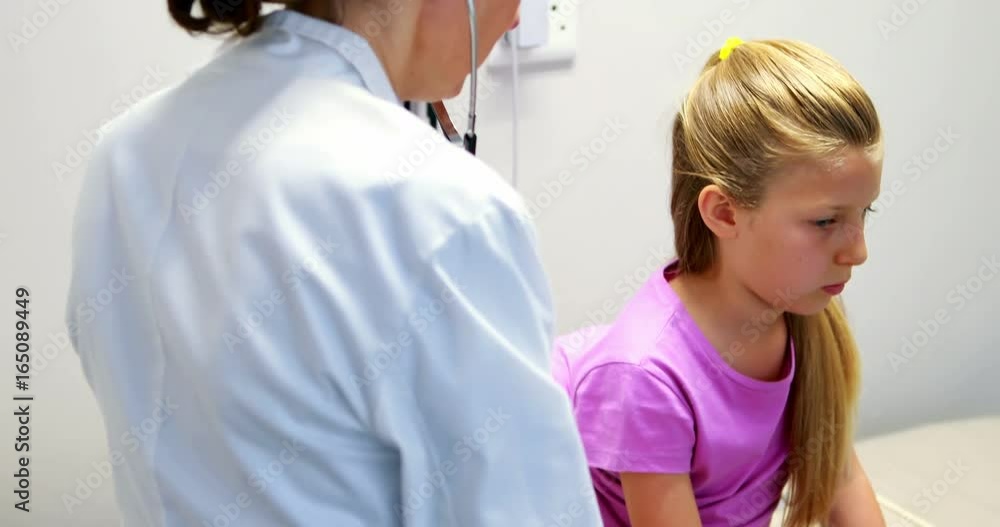 Female doctor examining a girl Female doctor examining a girl