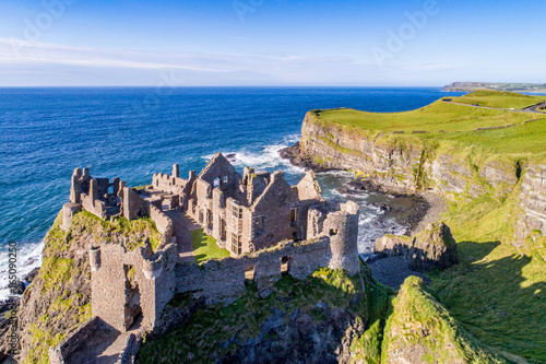 Ruins of medieval Dunluce Castle  cliffs  bays and peninsulas. Northern coast of County Antrim  Northern Ireland  UK. Aerial view.