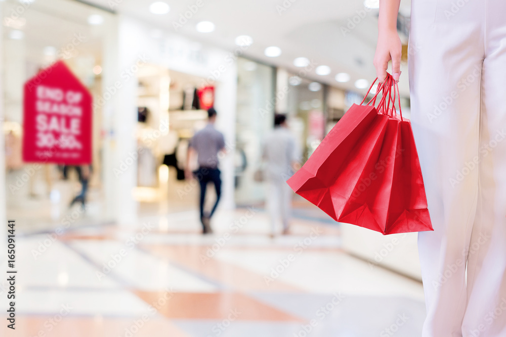 Woman with shopping bags in shopping mall, consumerism and sale concept. Woman with shopping bags in shopping mall, consumerism and sale concept.