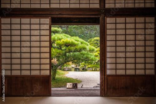 Japanese garden seen through sliding door.