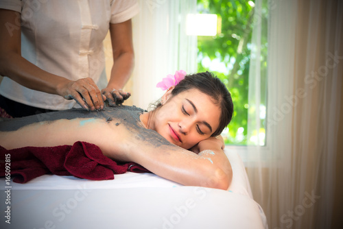 Masseur doing massage spa with treatment mud on Asian woman body in the Thai spa lifestyle  so relax and luxury.  Healthy Concept