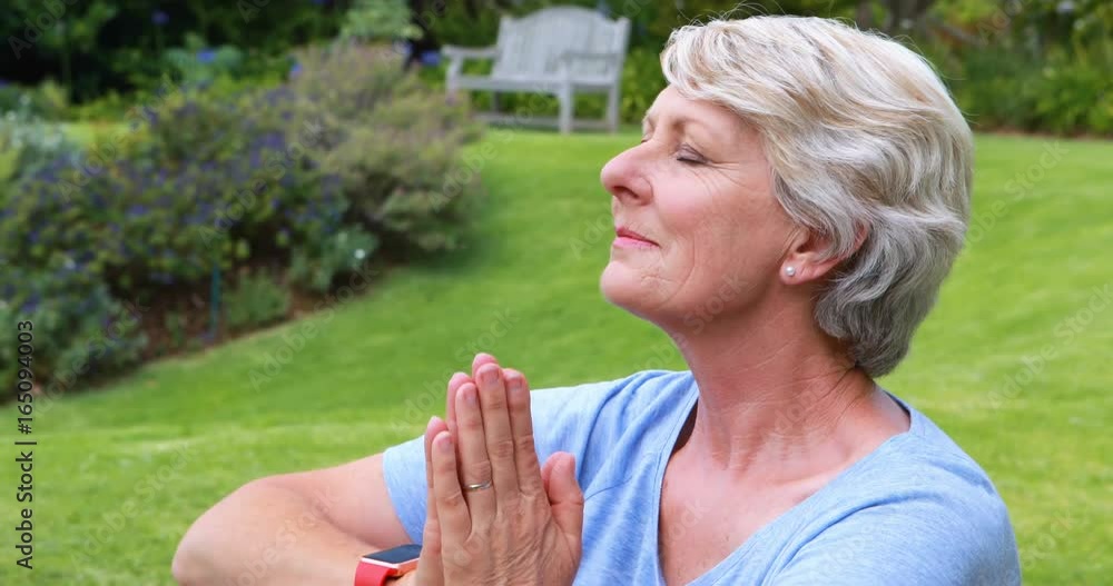 Senior woman performing yoga in garden Senior woman performing yoga in garden