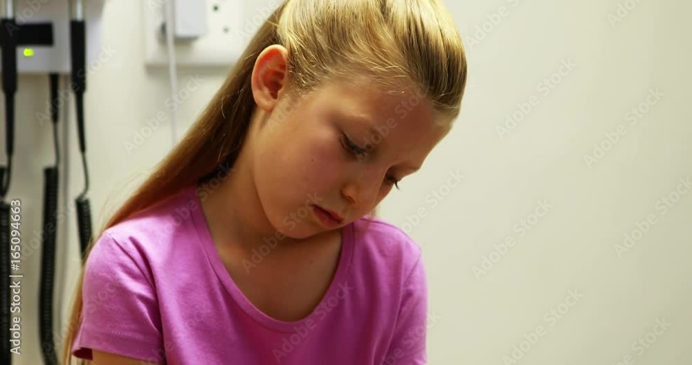 Injured girl sitting on stretcher bed Injured girl sitting on stretcher bed