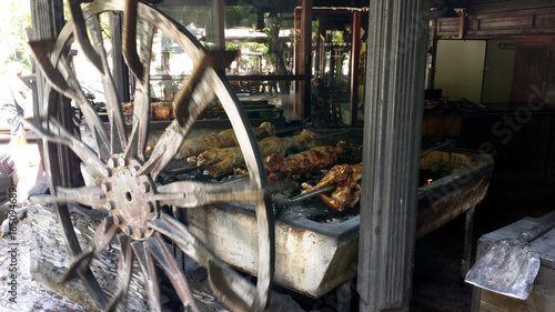 Baking lamb on a spit. Wheel rotates the barbecue. photo