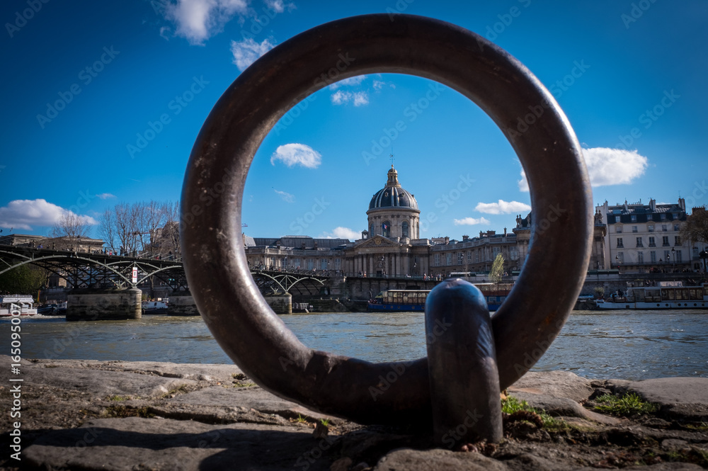 Fototapeta premium View across River Seine Paris through a mooring ring