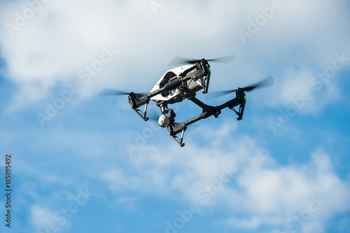 Fototapeta Naklejka Na Ścianę i Meble -  Drone in sky.Selective focus/Drone with camera flies in sky on clouds background