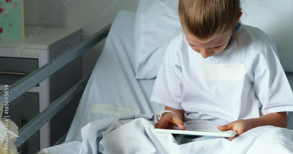 Sick girl using digital tablet on bed Sick girl using digital tablet on bed