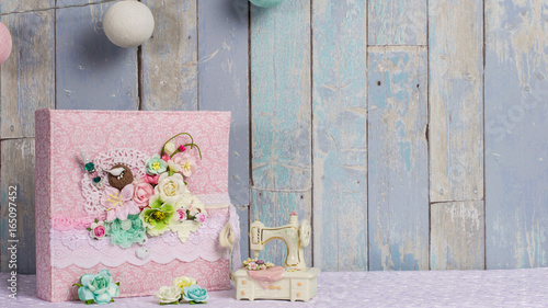 a photo album in the style of shabby chic on a blue background. photo