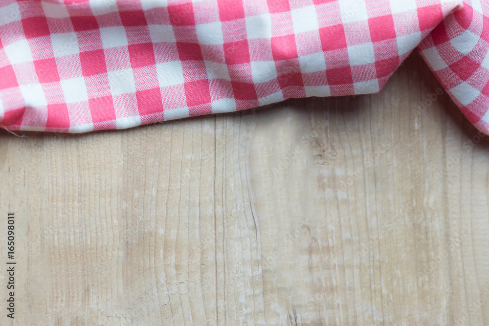 Red plaid on wooden table. high angle view Red plaid on wooden table. high angle view