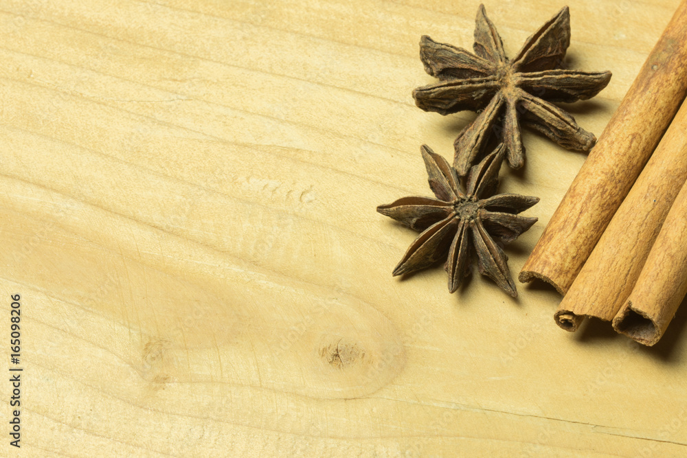 High angle view anise and cinnamon sticks on wooden table High angle view anise and cinnamon sticks on wooden table
