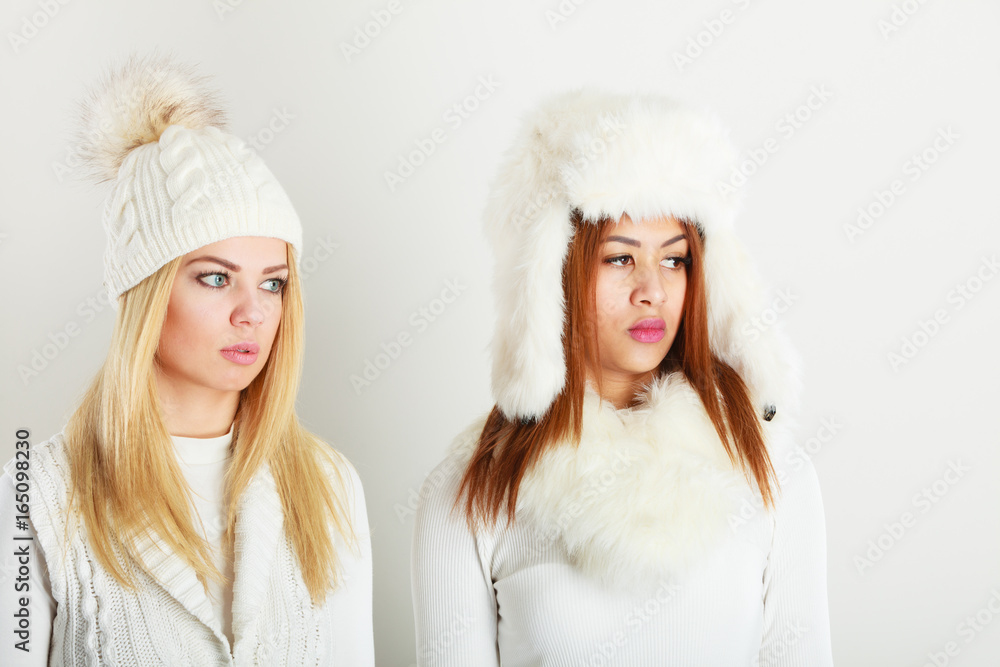 Two ladies in winter white outfit. Two ladies in winter white outfit.