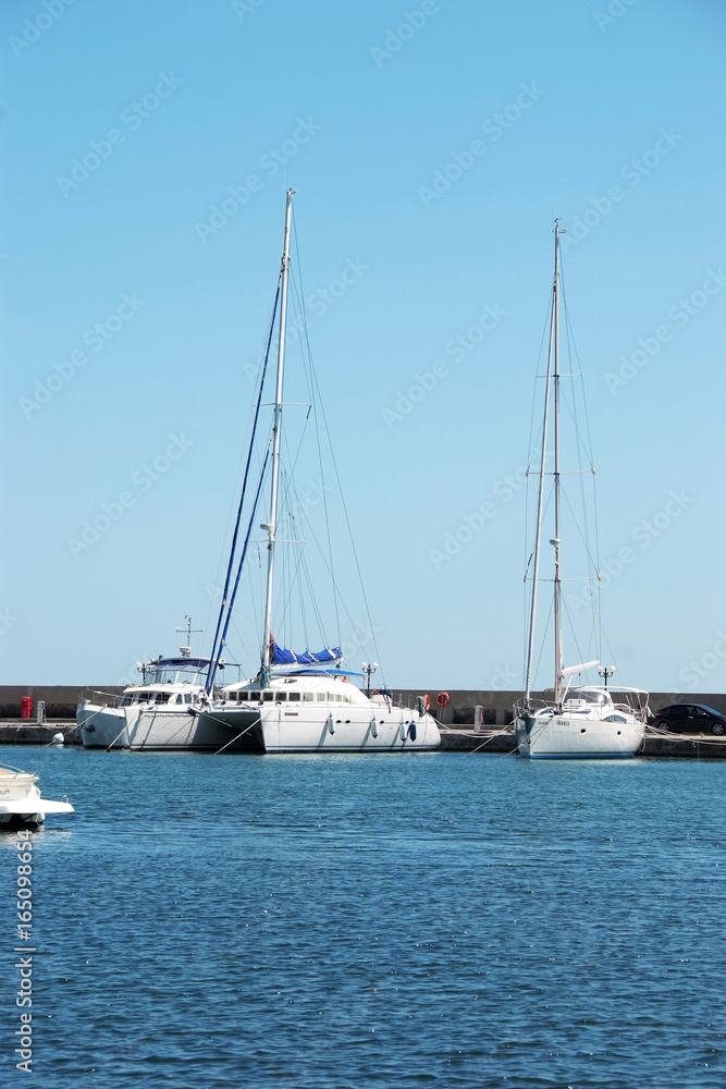 Three white yacht on the dock in the Bay on the black sea in Bulgaria in the resort