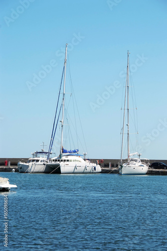 Three white yacht on the dock in the Bay on the black sea in Bulgaria in the resort