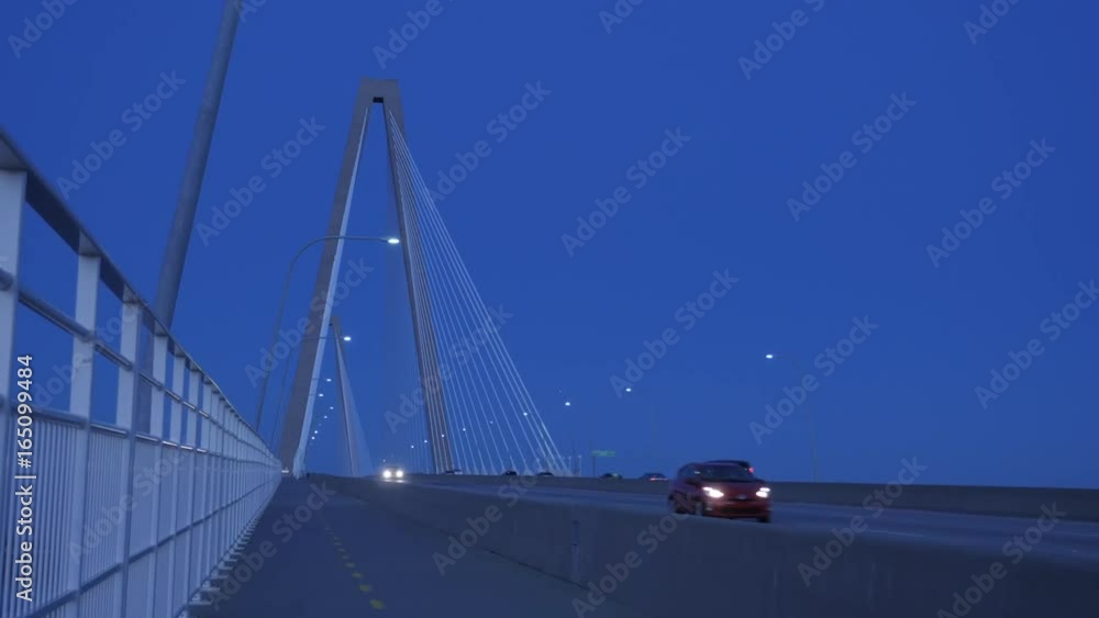 Cars drive over bridge during early morning. Cars drive over bridge during early morning.