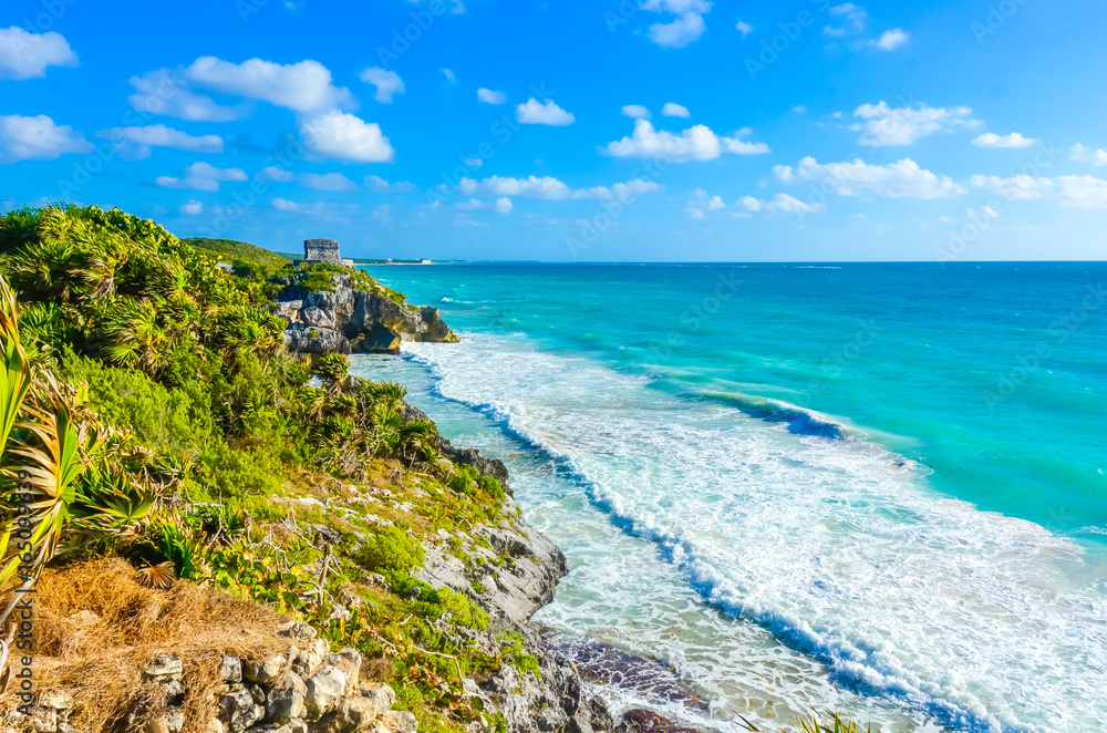 Mayan ruins of Tulum at tropical coast. God of Winds Temple at paradise beach. Mayan ruins of Tulum, Quintana Roo, Mexico. Mayan ruins of Tulum at tropical coast. God of Winds Temple at paradise beach. Mayan ruins of Tulum, Quintana Roo, Mexico.