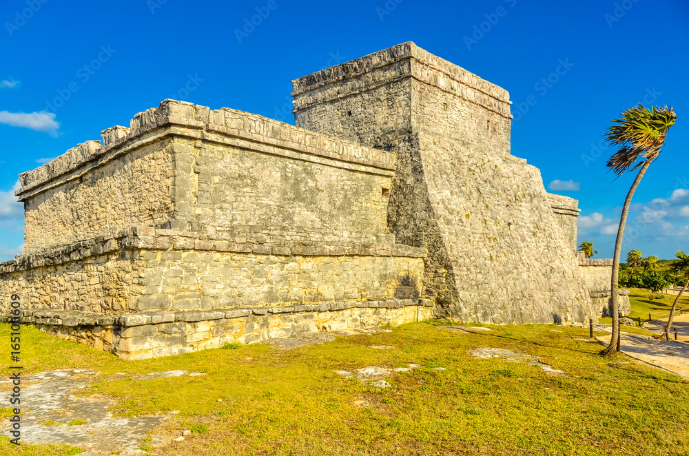 Mayan ruins of Tulum at tropical coast. El Castillo Temple at paradise beach. Mayan ruins of Tulum, Quintana Roo, Mexico.