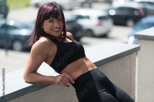 Fitness Woman Resting On Concrete Outdoors