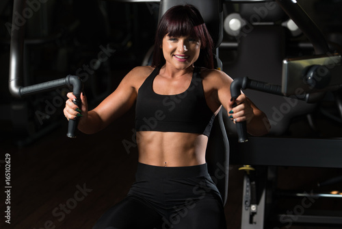Woman Exercising Chest On Machine
