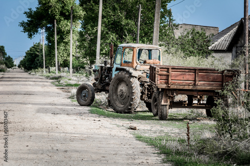 Agricultural tractor trailer near a rural street road close up