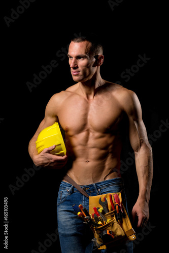 sexy fit shirtless worker with saw and tools