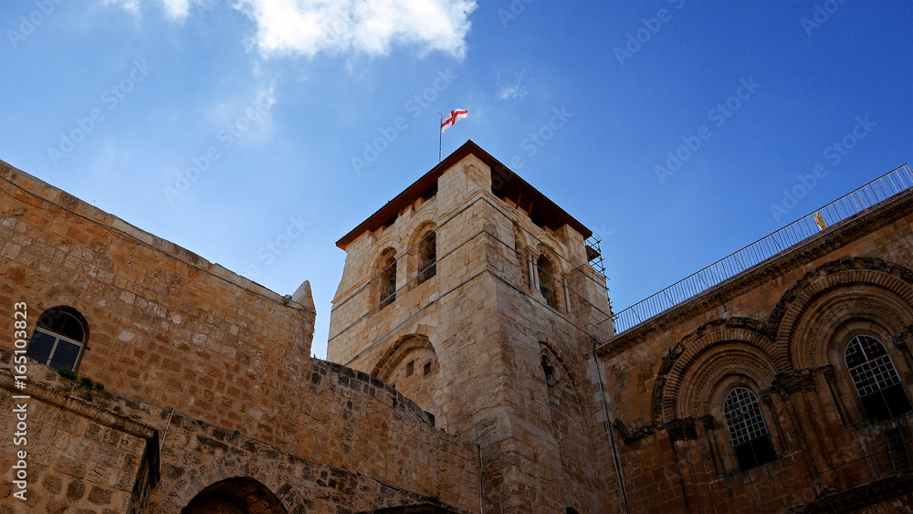 Roof of the Holy Sepulcher Church in Jerusalem with flying flag. The Holy Sepulchre Church and Empty Tomb the most sacred places for all religious Christians in the world. Calvary also located there.