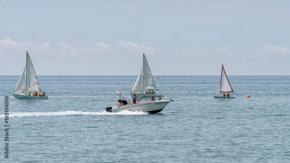 Fototapeta premium Rest on sea. Motor boat, boats with sail. Outdoor sea sporting activity