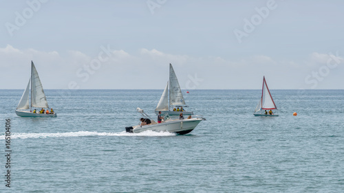 Rest on sea. Motor boat, boats with sail. Outdoor sea sporting activity