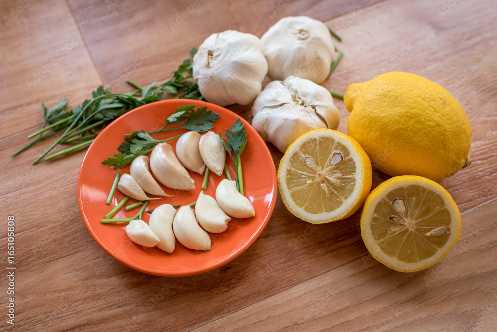 Mix of vegetables garlic lemon and parsley on a table for preparing healthy diet receipt Mix of vegetables garlic lemon and parsley on a table for preparing healthy diet receipt