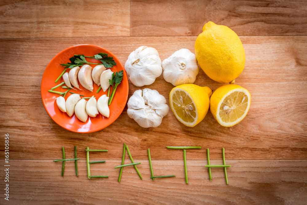 Mix of vegetables garlic lemon and parsley on a table for preparing healthy diet receipt Mix of vegetables garlic lemon and parsley on a table for preparing healthy diet receipt