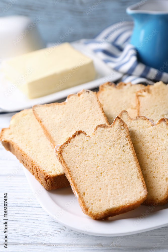 Plate with delicious sliced butter cake on wooden table Plate with delicious sliced butter cake on wooden table