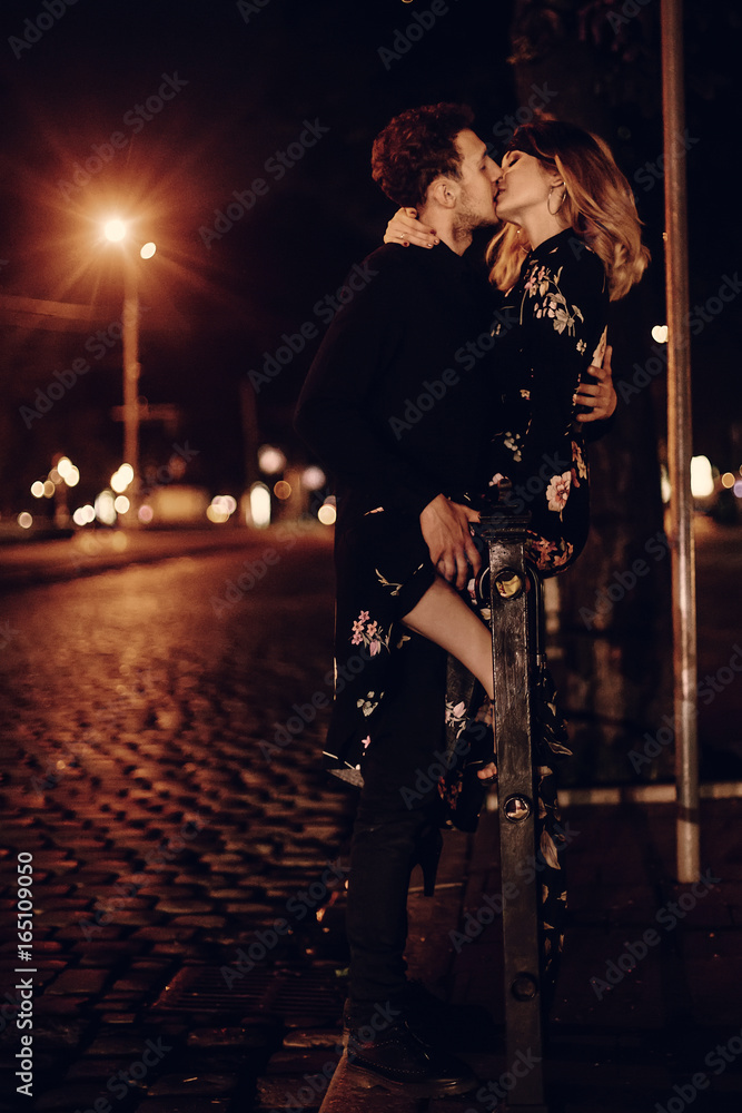 Sexy couple kissing outdoors in the street, two lovers kiss in night street  in Paris on their honeymoon, passion concept Stock Photo | Adobe Stock
