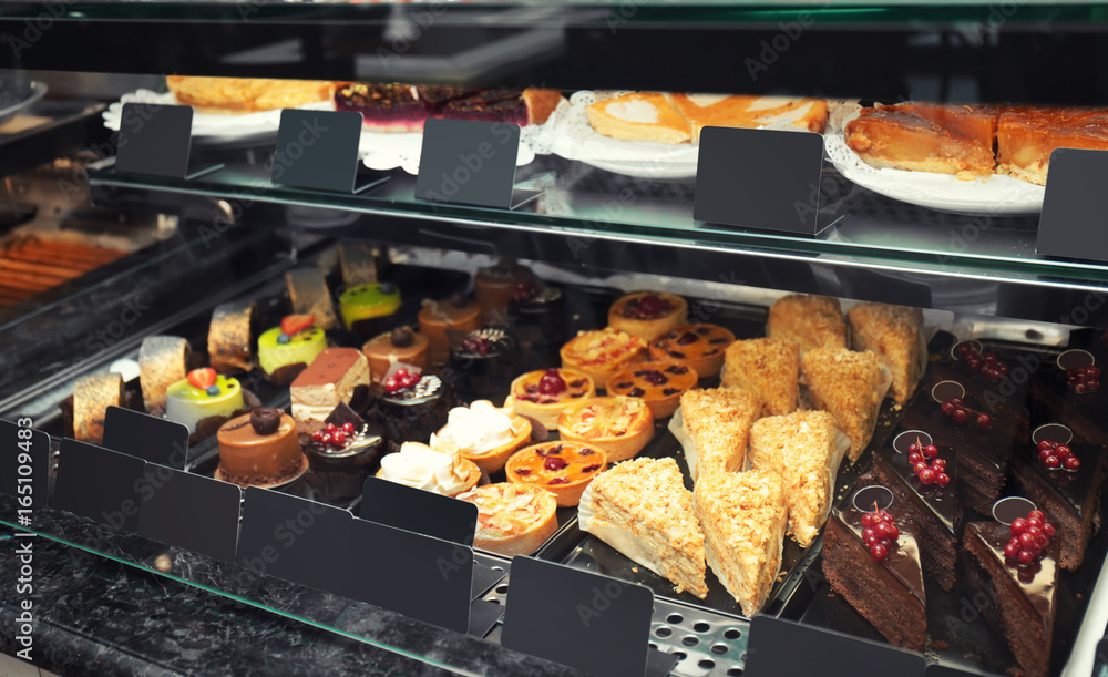 Fridge with cakes in shop, closeup Fridge with cakes in shop, closeup