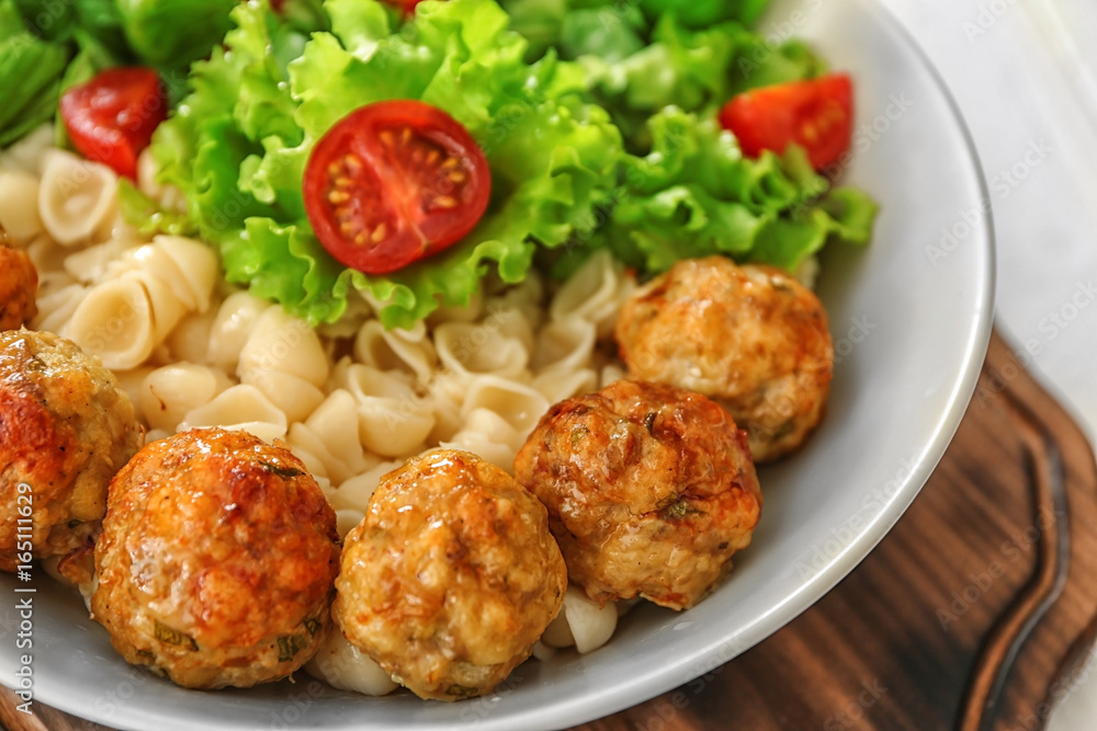 Plate with turkey meatballs and pasta on table, closeup Plate with turkey meatballs and pasta on table, closeup