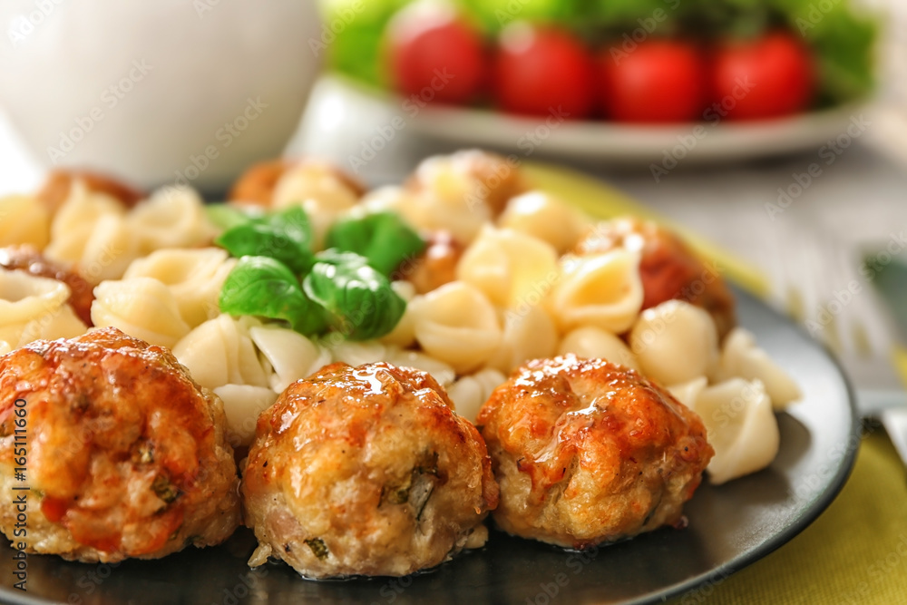 Plate with turkey meatballs and pasta on table, closeup Plate with turkey meatballs and pasta on table, closeup