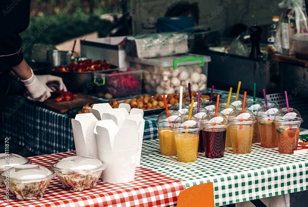 colorful lemonade on table and fast food paper boxes, space for text. street food festival