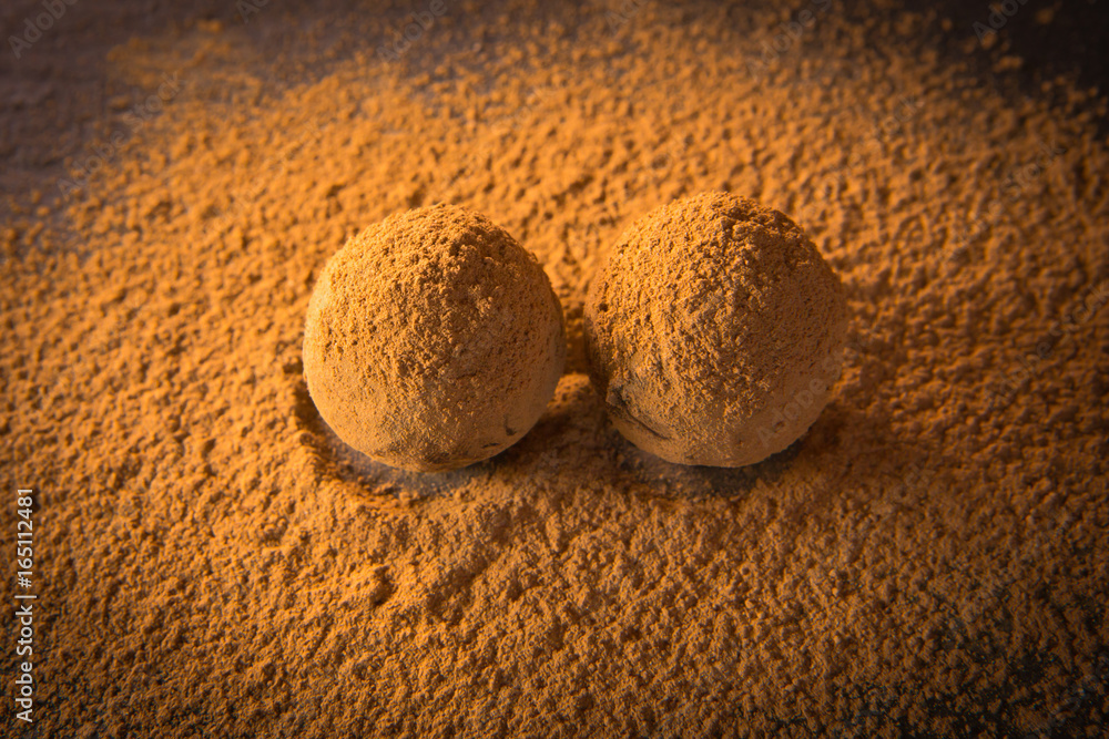 Truffle chocolate candies on cocoa powder. Best chocolate truffles