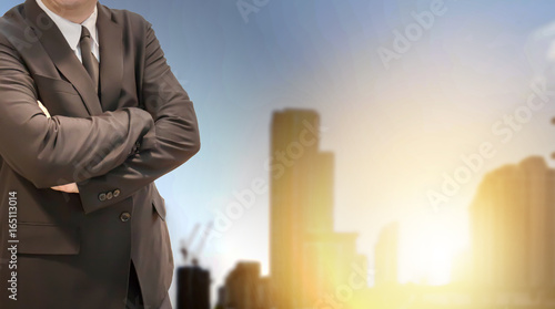 business man in black suit with blur background city