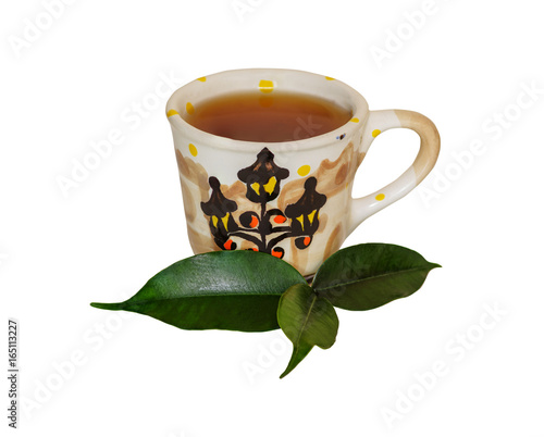 Tea leaf and cup of tea on a white background