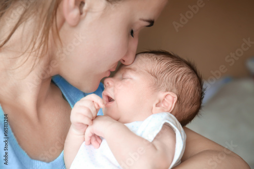 Happy young woman kissing h...