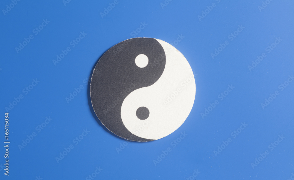 Yin-Yang symbol made of paper on blue background. Yin-Yang symbol made of paper on blue background.