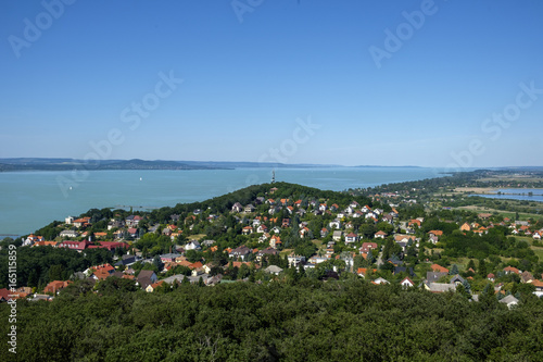 small town in foreground, the blue and green lake in background - summertime and vacation at Balaton