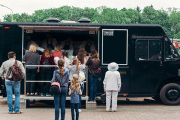 food van truck. group of people customers at mobile van with burgers and bbq at street food festival. food truck with snacks and drinks at eating market
