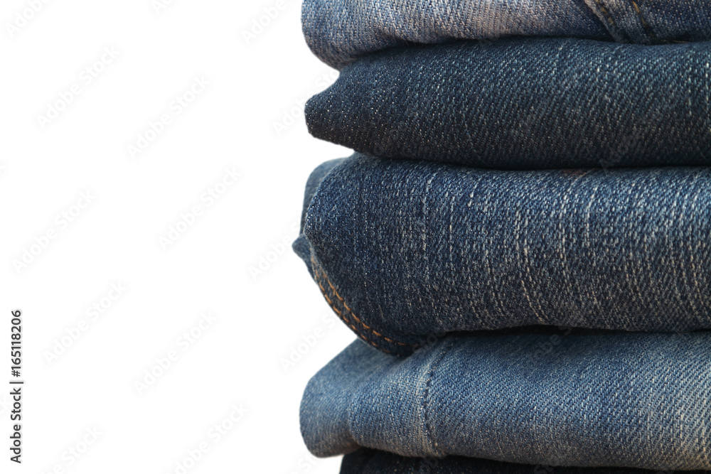jeans stacked on a wooden table and white background,Pile of jeans jeans stacked on a wooden table and white background,Pile of jeans