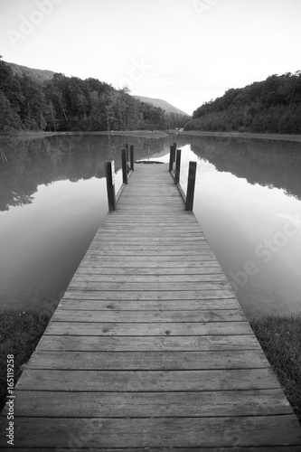 Dock on a Lake with Reflective Surface and Dramatic Perspective