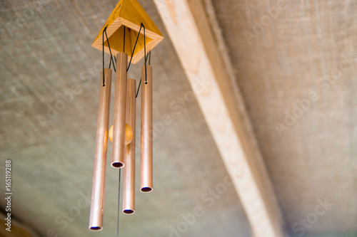 a wind chime under the roof of the restaurant in Thailand