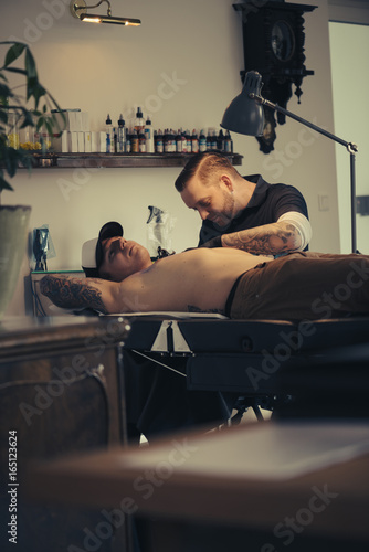 Tattoo artist Rolf Bergmann at work photo
