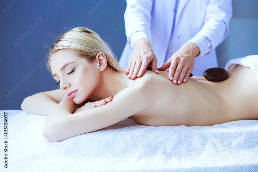Obraz premium Young woman lying on a massage table,relaxing with eyes closed. Woman. Spa salon