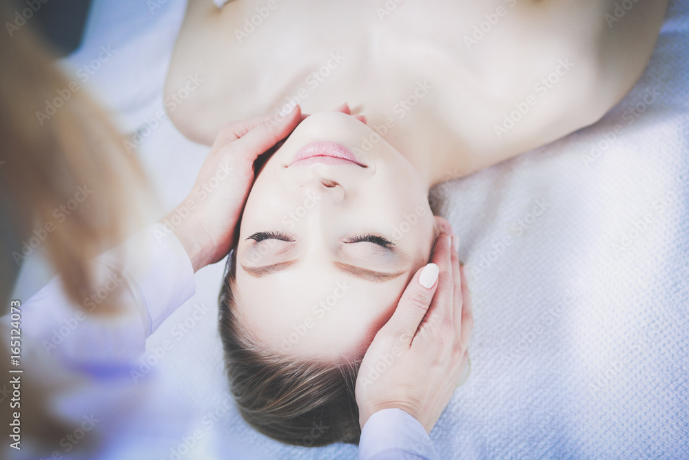 Young woman lying on a massage table,relaxing with eyes closed. Woman. Spa salon Young woman lying on a massage table,relaxing with eyes closed. Woman. Spa salon