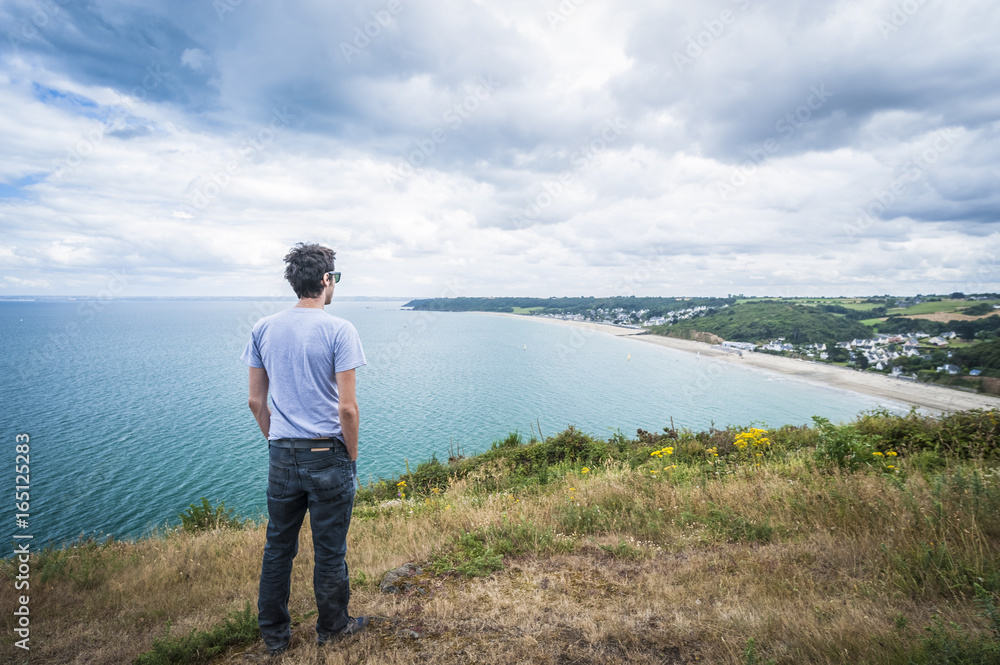 Man looking panorama in Brittany - France Man looking panorama in Brittany - France