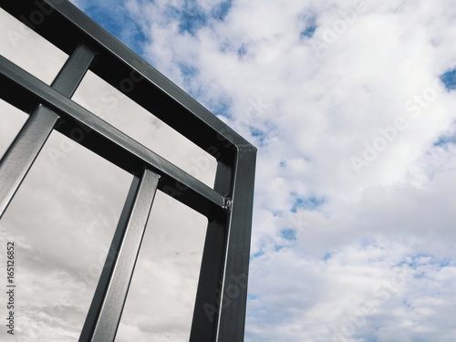 Metal structure against cloudy skies 